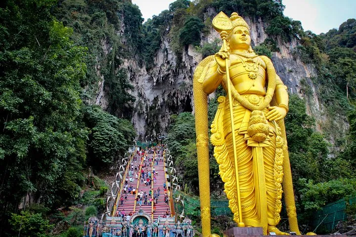 The golden Lord Murugan statue and the staircase to Temple Cave at Batu Caves