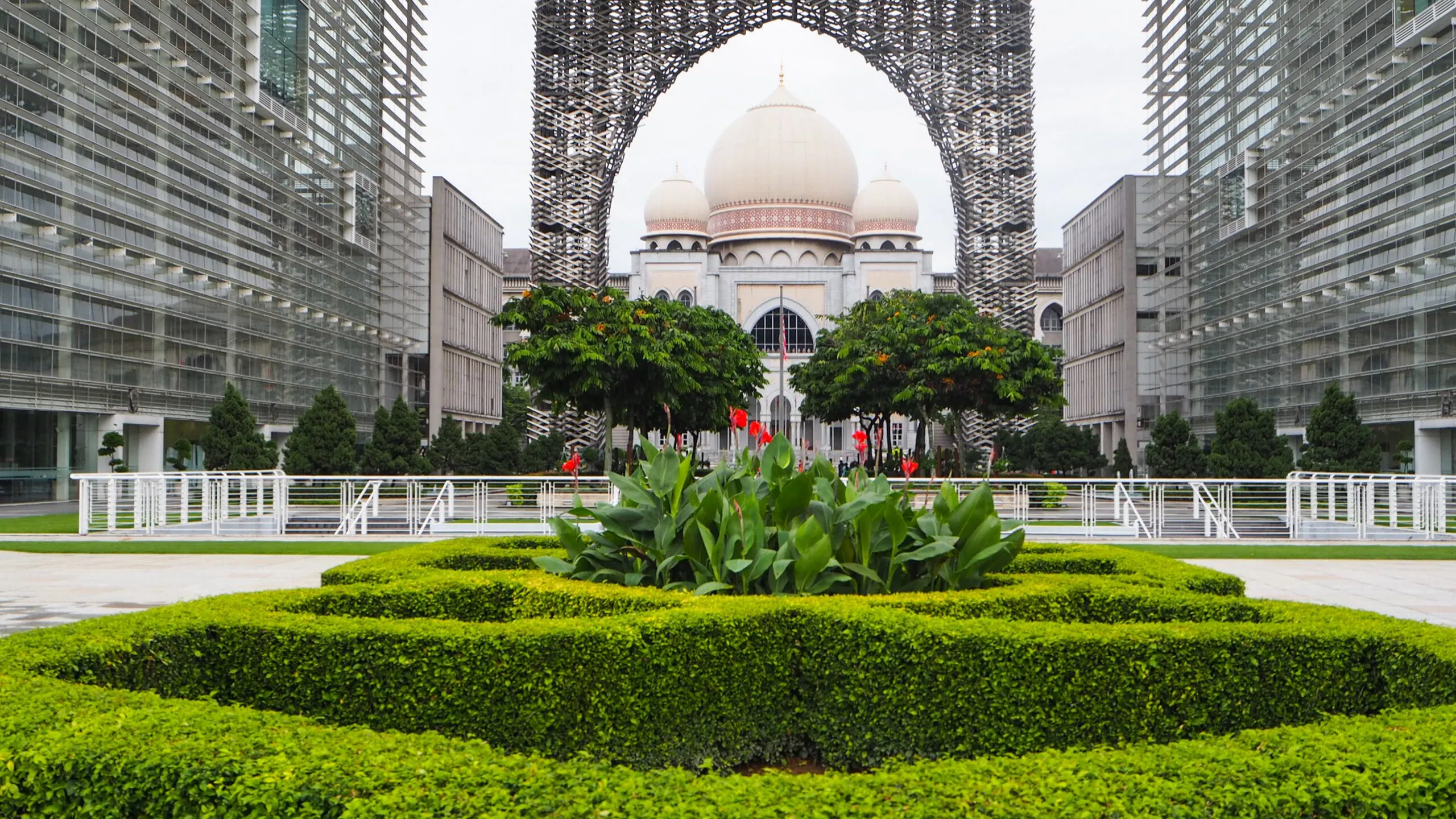 The domed Palace of Justice in Putrajaya, framed through a ministry archway